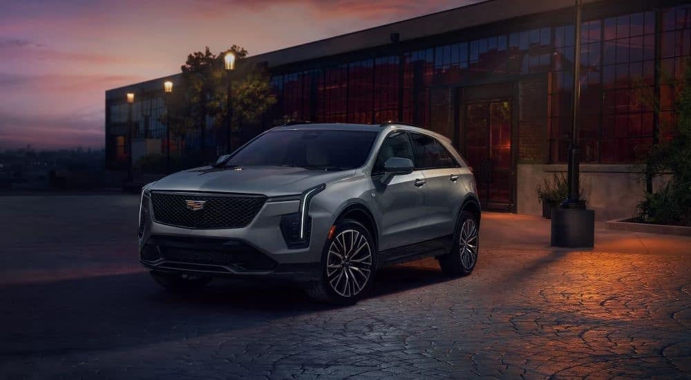A silver 2024 Cadillac XT4 is shown at dusk after leaving a Cadillac dealer.