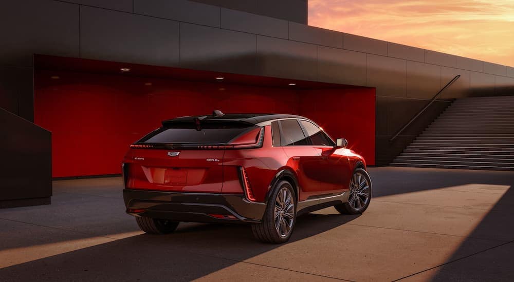 A red 2024 Cadillac LYRIQ is shown from a rear angle.