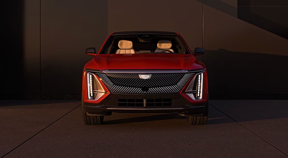 A front view of a red 2024 Cadillac LYRIQ parked in a garage.