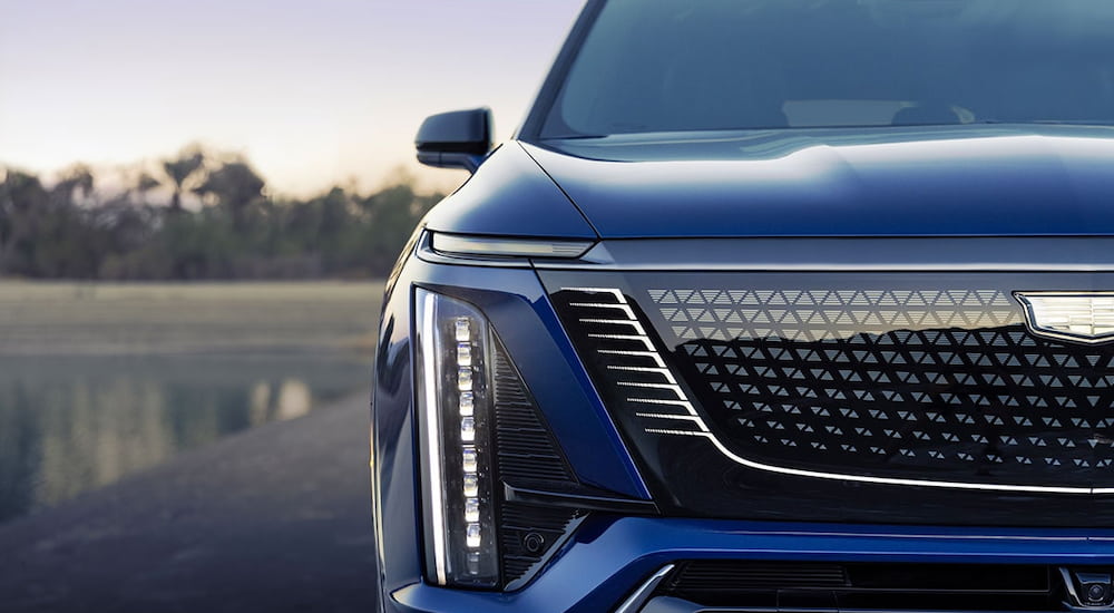 Close-up on the headlight and grille of a blue 2026 Cadillac VISTIQ.