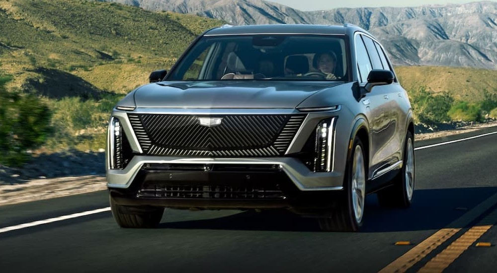 A silver 2026 Cadillac VISTIQ driving on a highway.