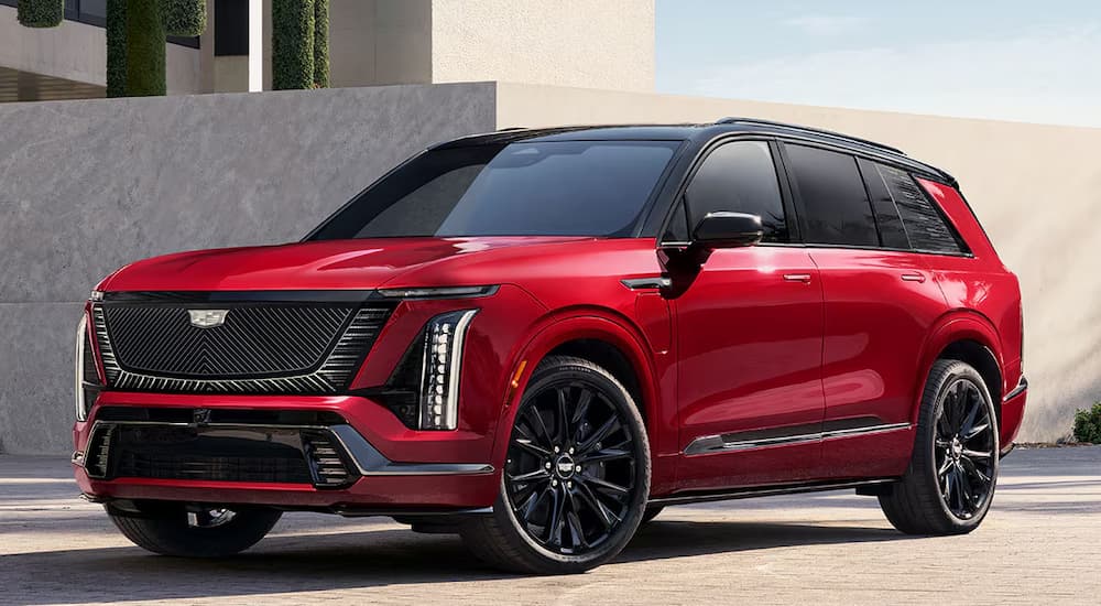 A red 2026 Cadillac VISTIQ parked outside a building