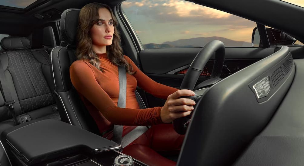 A person driving in a 2027 Cadillac LYRIQ.