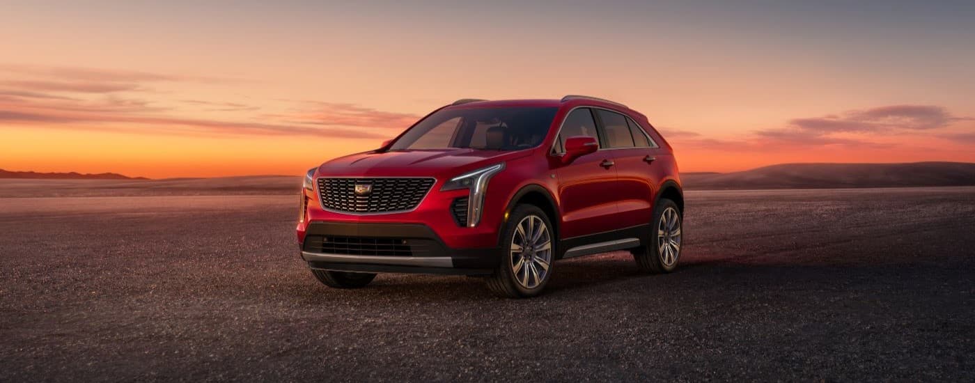 Red 2023 Cadillac XT4 parked off-road.