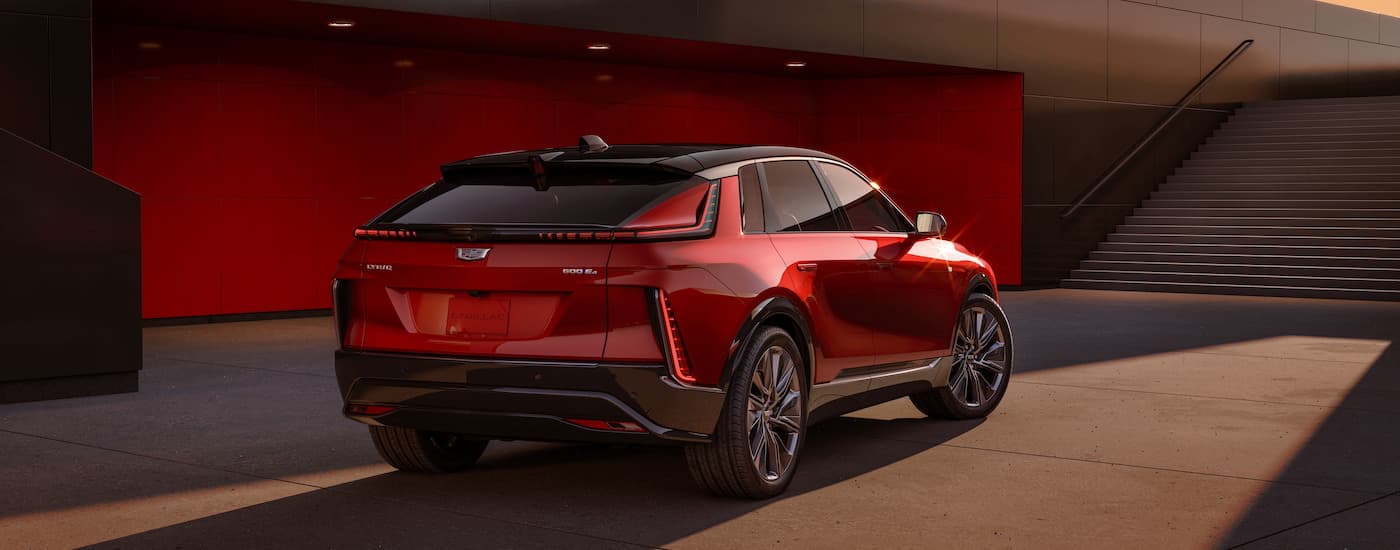 Rear view of a red 2024 Cadillac LYRIQ parked at a Cadillac dealer near Troy.