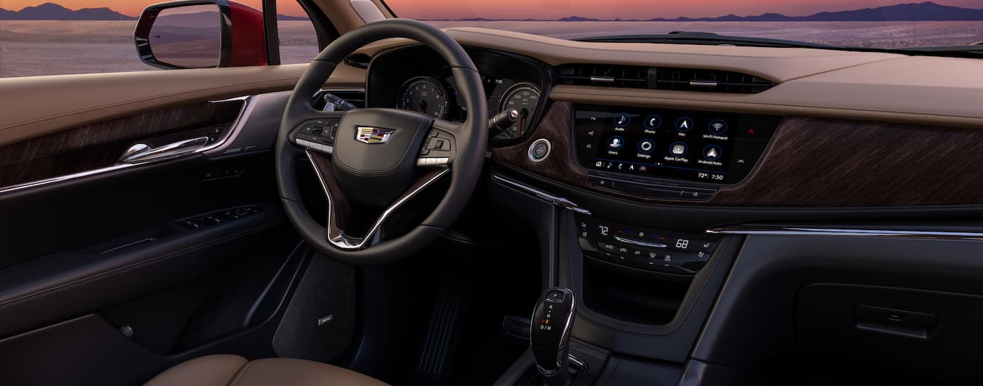 The black interior of a 2024 Cadillac XT6 is shown from the passenger side