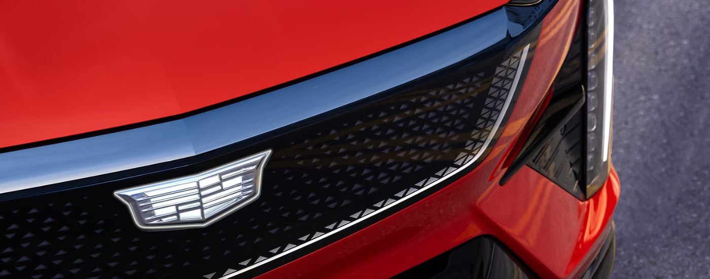 Close up of the grill on a red 2026 Cadillac OPTIQ.
