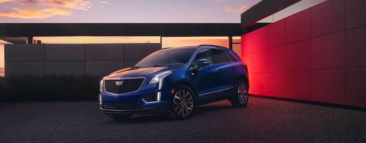 A blue 2024 Cadillac XT5 parked at sunset.