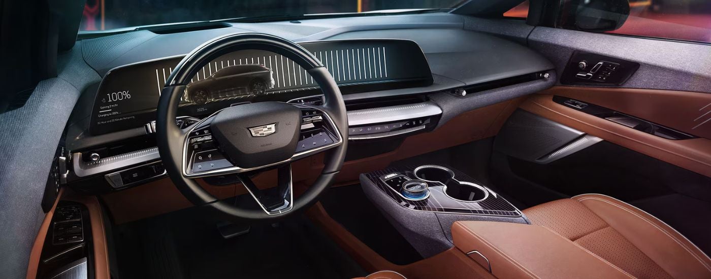 Brown leather upholstery in the cabin of a 2025 Cadillac OPTIQ at a Cadillac dealer near Commerce Township.