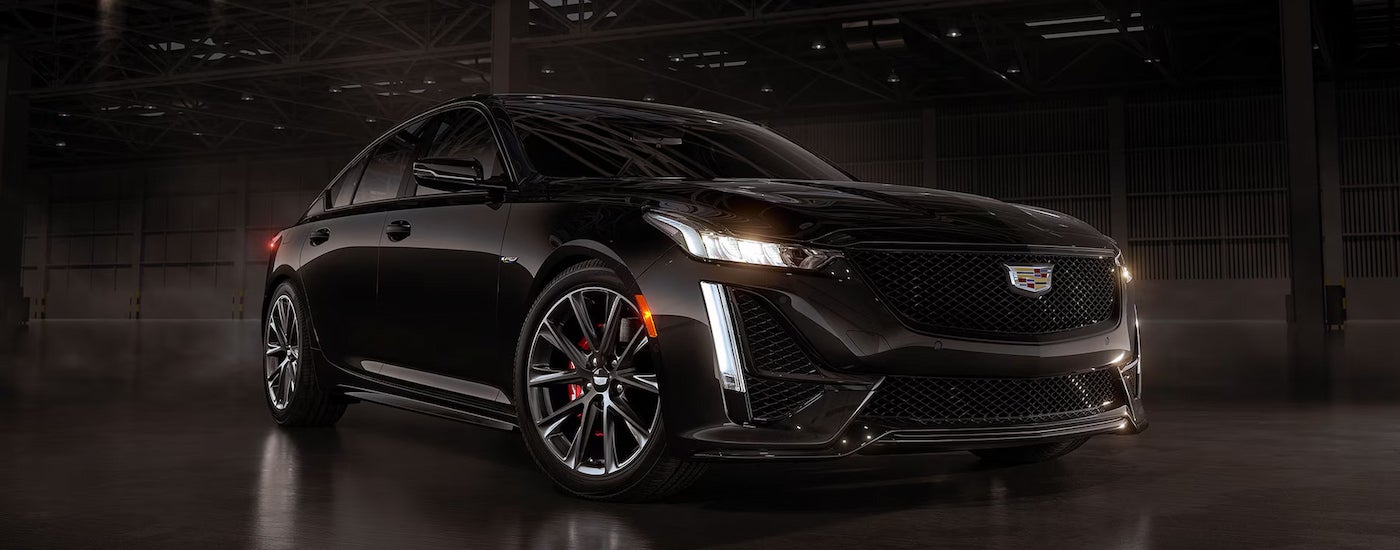 A black 2024 Cadillac CT5-V parked in a warehouse.