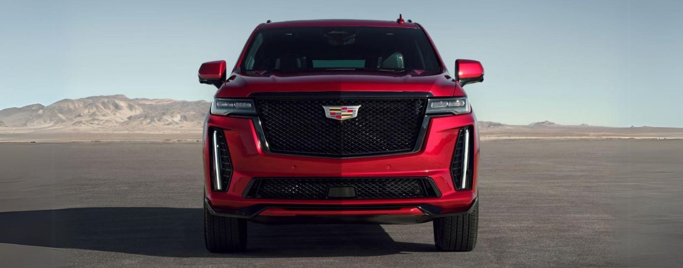 A red 2023 Cadillac Escalade V-Series parked after leaving a Cadillac dealer in Highland Township.