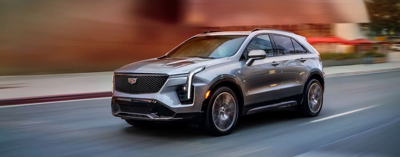 A silver 2025 Cadillac XT4 driving to a Cadillac dealer near Ann Arbor.