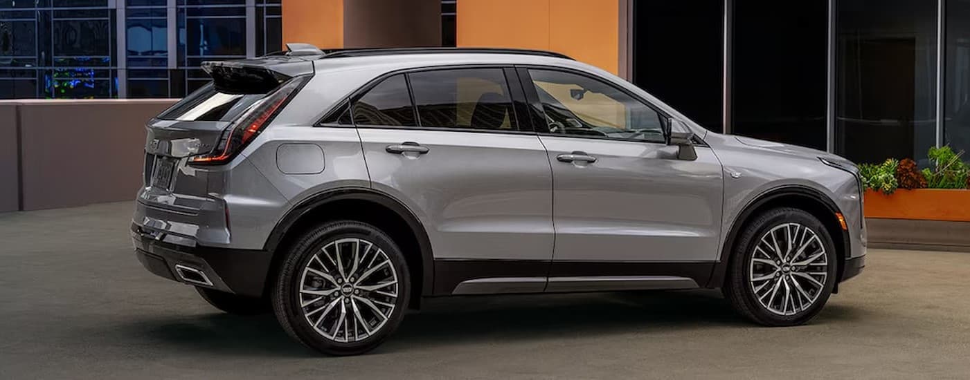 A silver 2024 Cadillac XT4 parked on a driveway.