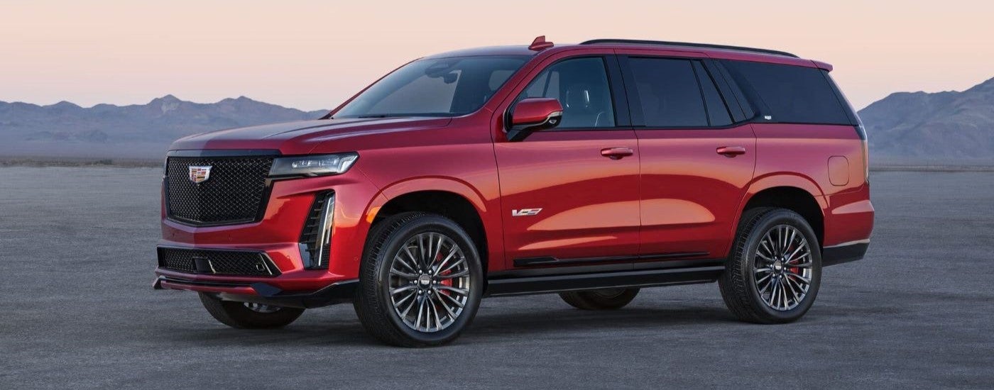 Side view of a red 2023 Cadillac Escalade-V parked.