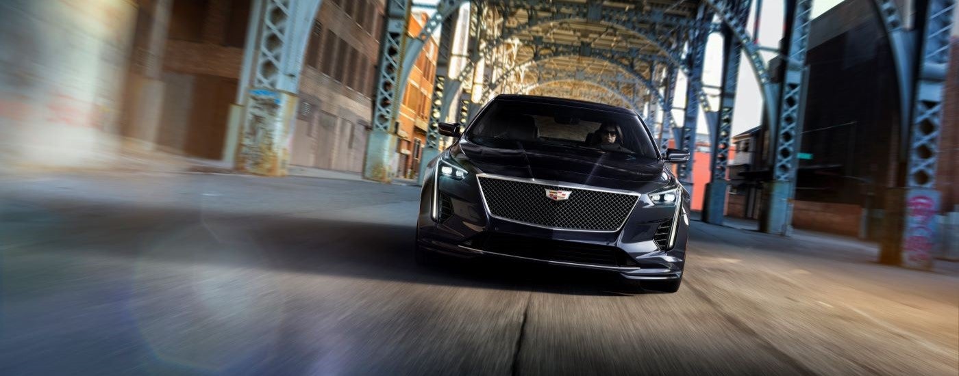 Head-on view of a black 2019 Cadillac CT6-V driving under a bridge.