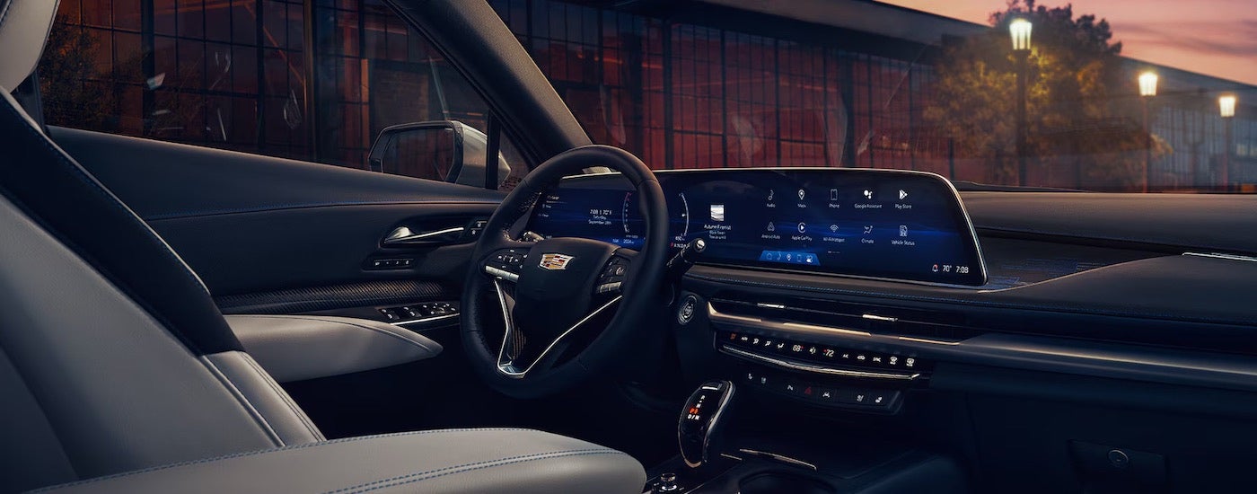 The black interior of a 2024 Cadillac XT4 is shown from the passenger seat.