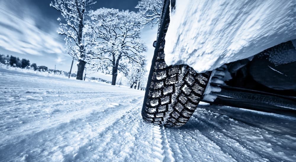 Close-up of a tire on a snowy road.